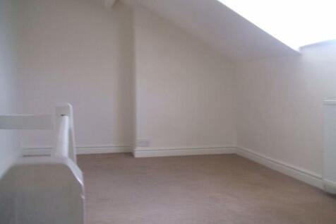 Bright attic-style single bedroom with neutral ...