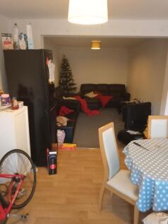 Open-plan living and dining area with a dining ...