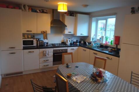 Bright modern kitchen with plenty of white cabi...