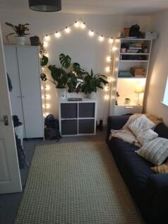 Cosy living room with a comfortable dark sofa, ...