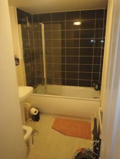 Well-appointed bathroom with a combined bath an...