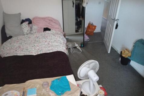 Cozy bedroom with a comfortable-looking bed, fu...