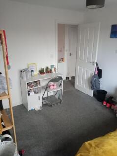 Bright, tidy bedroom with neutral décor, a comp...