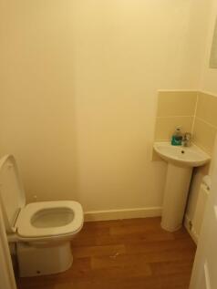 Compact downstairs WC with modern white toilet ...