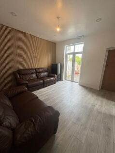 Contemporary living room with two brown leather...