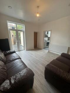 Bright ground-floor living room with large glaz...