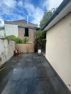Private paved courtyard with modern dark stone ...