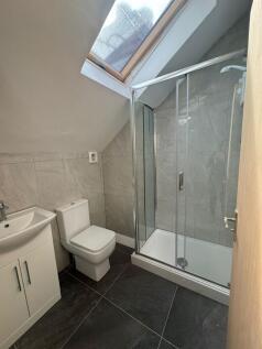 Bright modern bathroom with slate-style floor t...