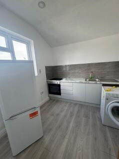 Bright, modern kitchen with light wood-effect f...