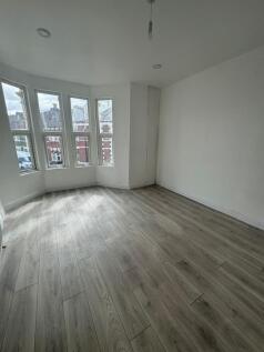 Bright, freshly renovated bedroom with a bay of...