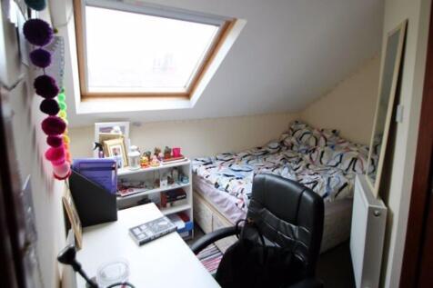 A bright and inviting bedroom featuring a doubl...