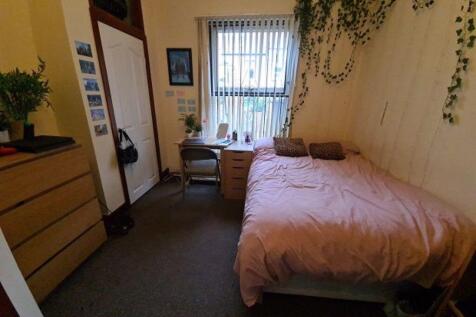 A cozy master bedroom featuring a double bed, a...