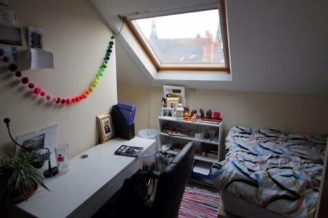 A cozy bedroom with natural light streaming thr...