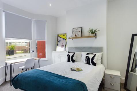 A bright and inviting double bedroom featuring ...