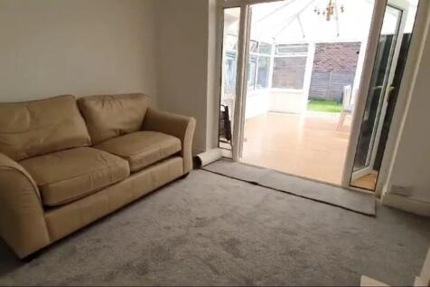 A cozy living room featuring a comfortable sofa...