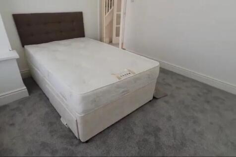 This inviting double bedroom features a comfort...