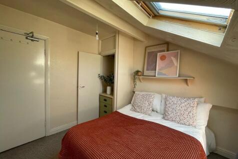 Cozy double bedroom featuring a comfortable bed...