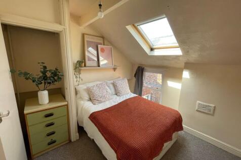 Cozy and inviting bedroom with natural light st...