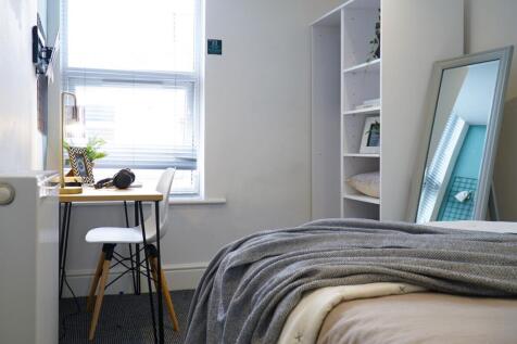 A bright and inviting double bedroom featuring ...