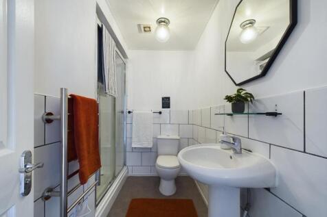 A modern and clean bathroom featuring a shower ...