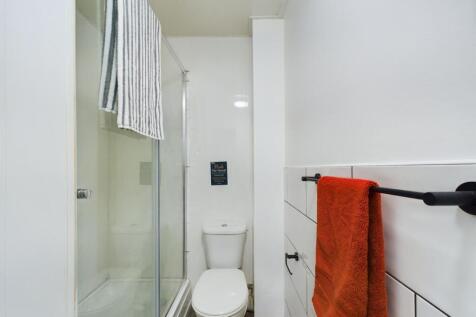 A modern and tidy bathroom featuring a spacious...