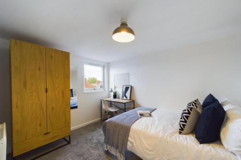 A bright and inviting double bedroom featuring ...