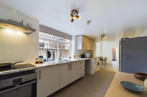 A spacious and modern kitchen with ample natura...