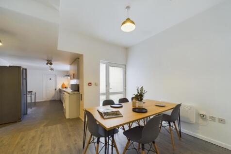 A spacious and bright kitchen area featuring a ...