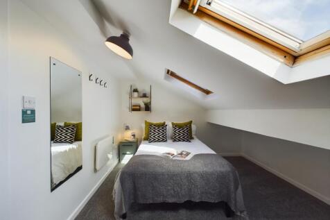 A bright and inviting double bedroom with moder...