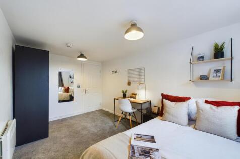 A spacious and inviting double bedroom featurin...