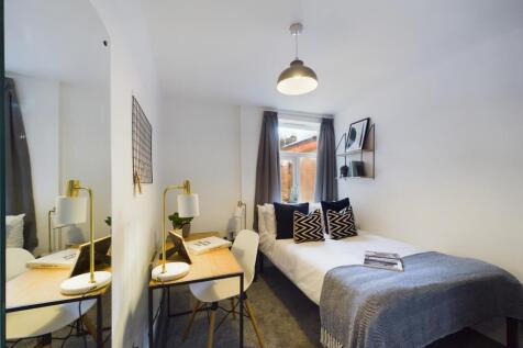 A bright and inviting double bedroom featuring ...