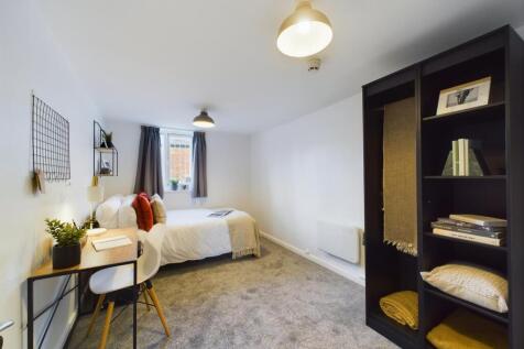 A spacious and inviting double bedroom featurin...
