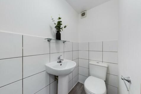 A clean and minimalist single toilet with moder...