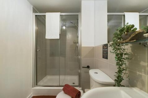 A clean, modern bathroom featuring a spacious s...