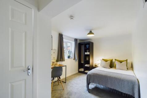 A bright and inviting double bedroom featuring ...