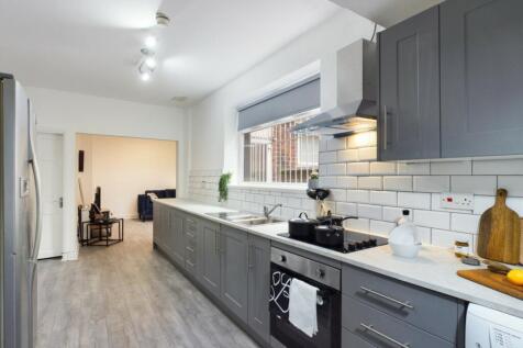 A modern and inviting kitchen, featuring ample ...