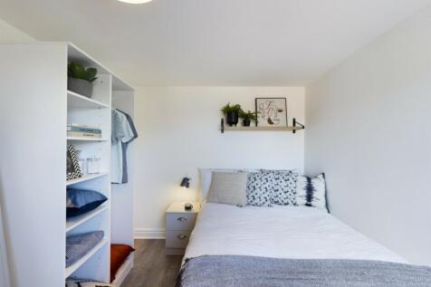 A bright and tidy double bedroom featuring styl...