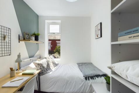 A bright and cozy double bedroom with modern de...