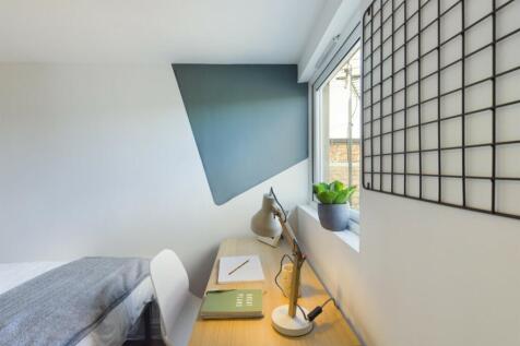 A bright and tidy double bedroom featuring a st...