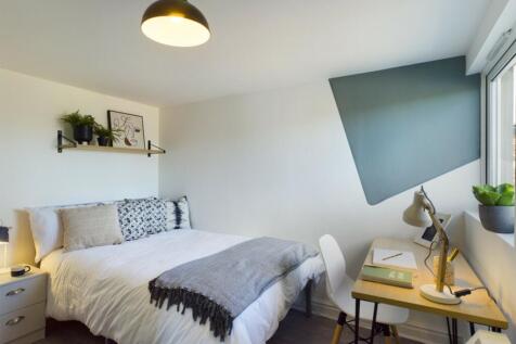 A bright and inviting double bedroom featuring ...