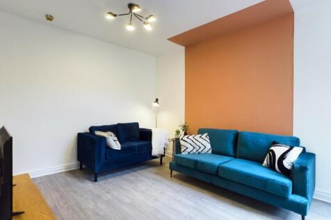 A stylish and spacious modern living room featu...