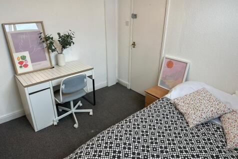 Bright and inviting bedroom featuring a comfort...