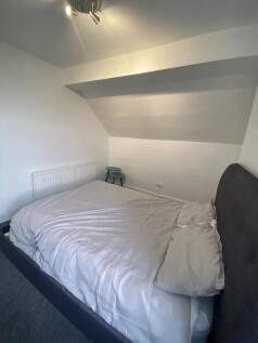 A cozy double bedroom with a comfortable bed, p...