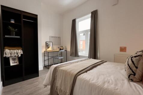 A bright and inviting double bedroom featuring ...