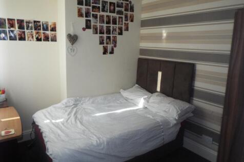 This inviting double bedroom features a cozy be...