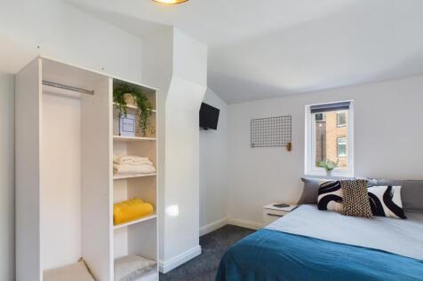 A bright and inviting double bedroom featuring ...