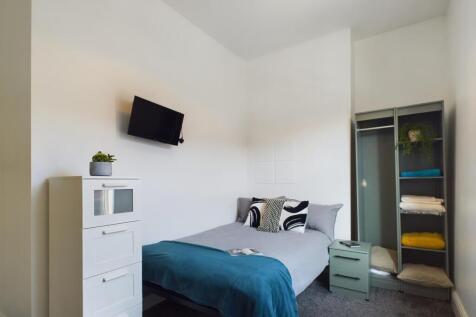 A bright and tidy double bedroom featuring styl...