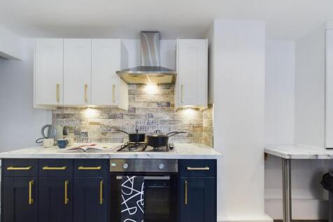 A modern and stylish kitchenette with ample sto...