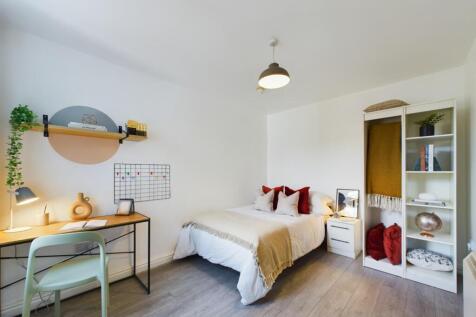 This inviting double bedroom features a cozy be...