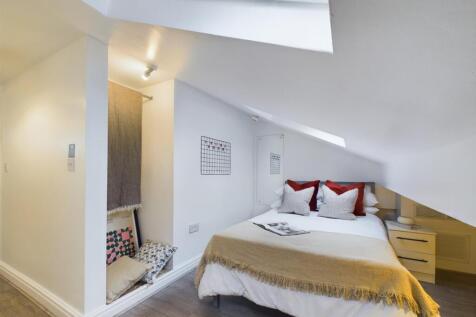 This charming double bedroom features a cozy la...